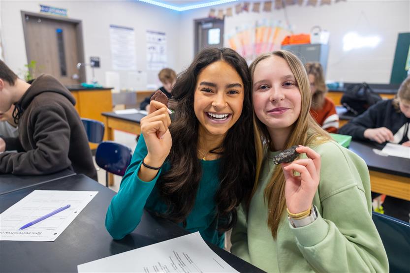Students study rocks in a science lab